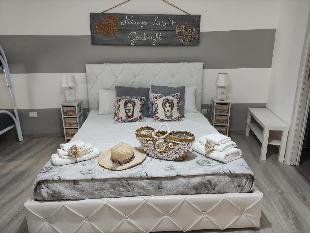 um quarto com uma cama com chapéus e toalhas em Sicilia Bedda house em Cefalù