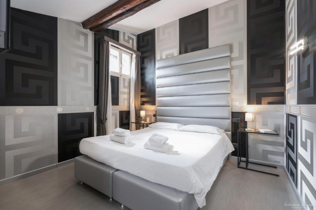 a bedroom with a bed with two towels on it at Hotel Spagna in Florence