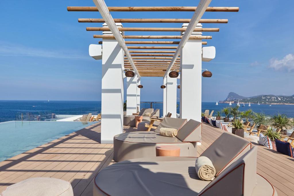 an outdoor patio with a view of the ocean at Can Salia in San Antonio Bay