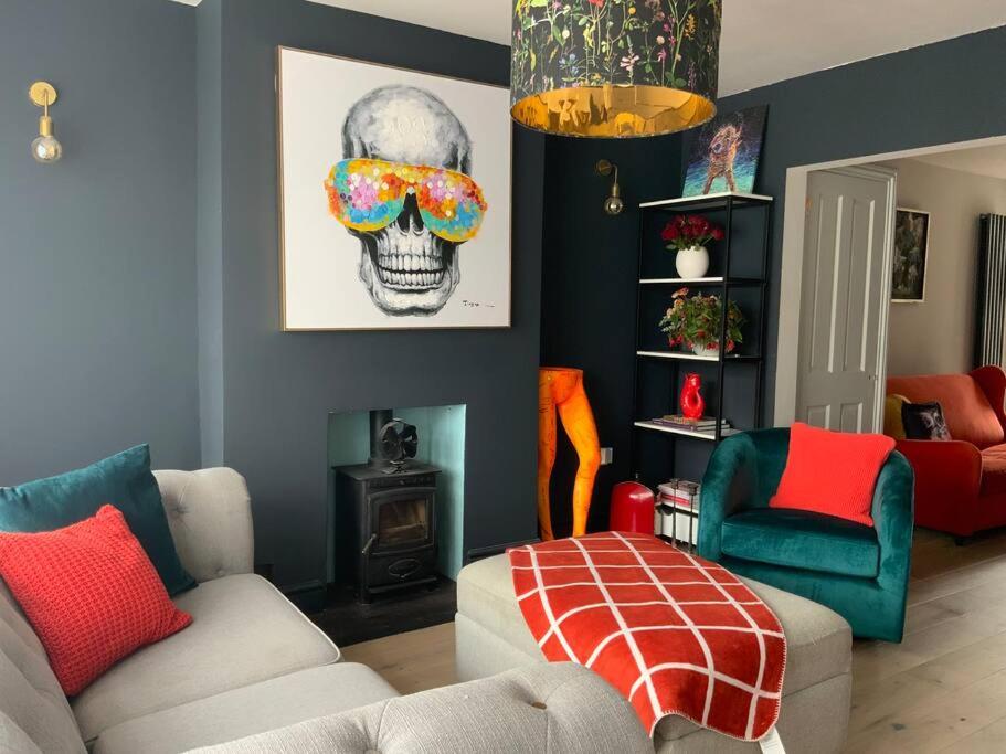 a living room with a couch and a skull on the wall at Selsey 5 mins walk to the beach in Selsey