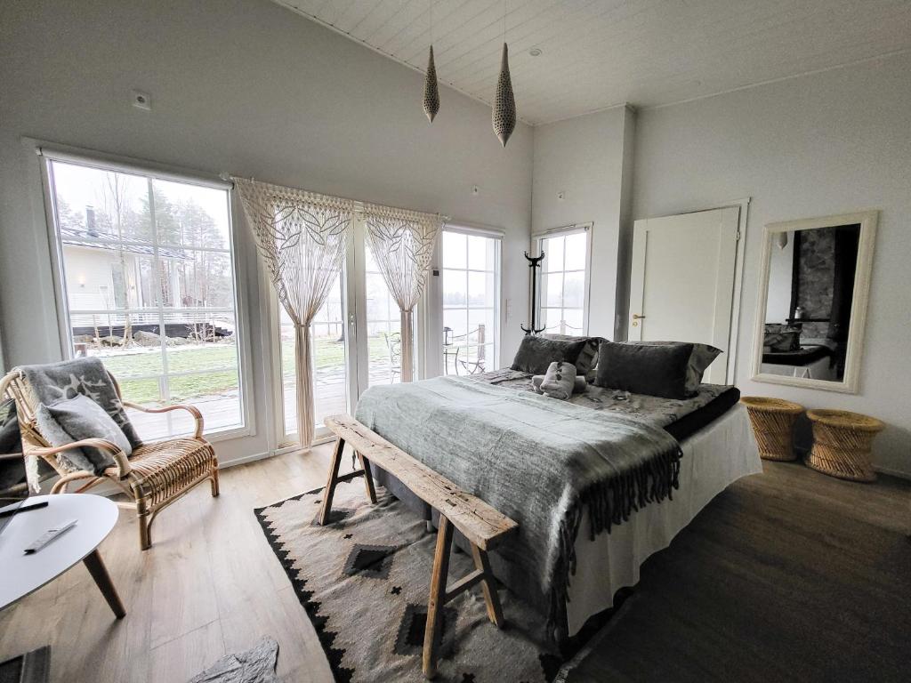 1 dormitorio con cama, mesa y ventanas en Lakehouse Oulu en Oulu