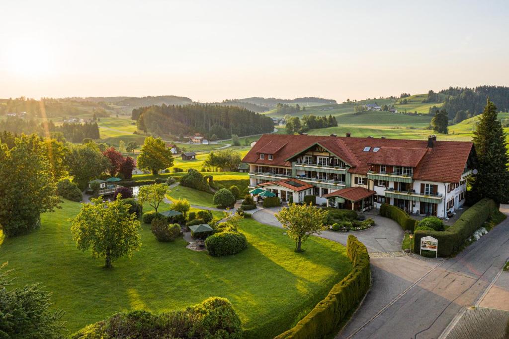 an aerial view of a large house with a garden at Hotel Johanneshof in Oberstaufen