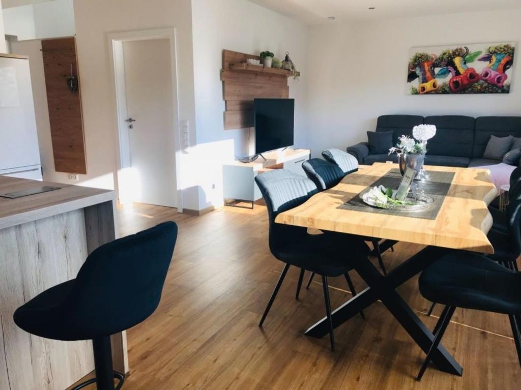 a living room with a dining room table and chairs at Ferienhaus Geest und Moor 1 in Großheide