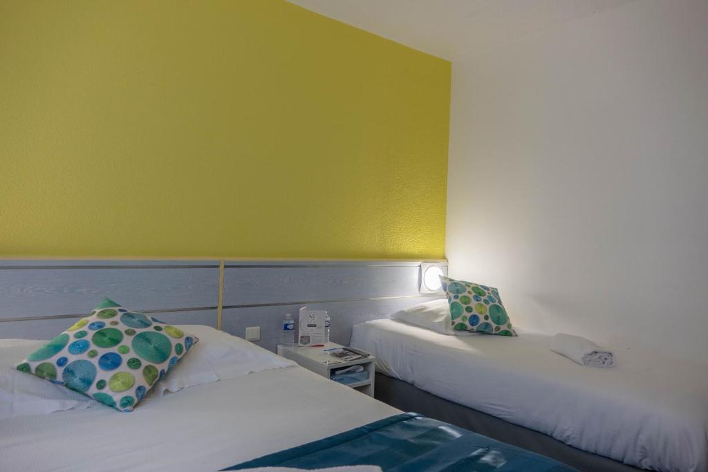 Postel nebo postele na pokoji v ubytování As Hotel Orléans Nord Artenay