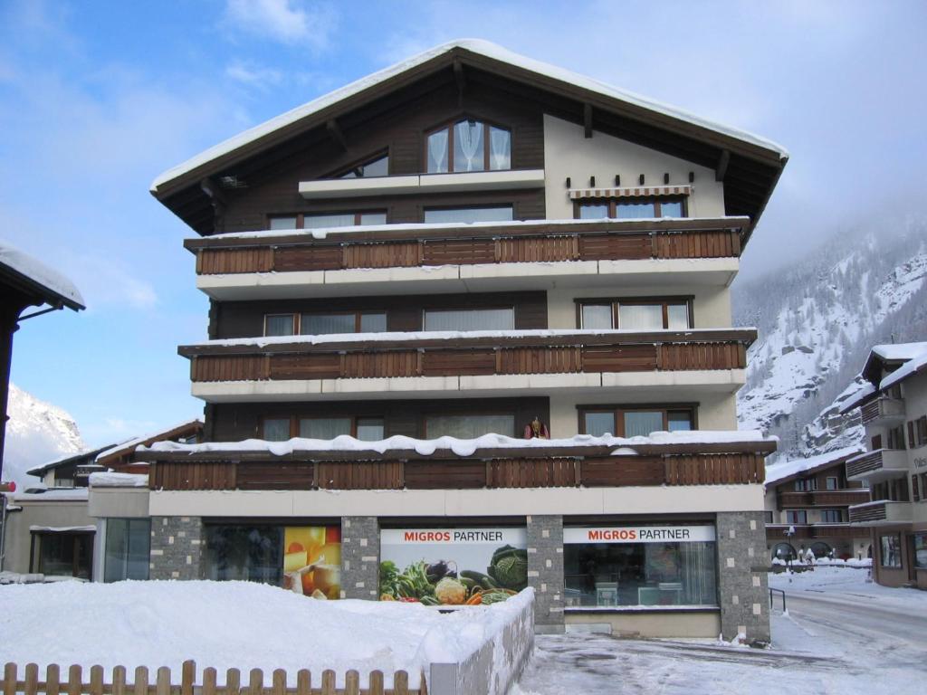 a large building with snow in front of it at Sportina in Saas-Grund