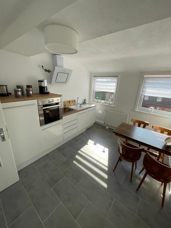 a kitchen with a table and a dining room at Fernweh Harz in Seesen
