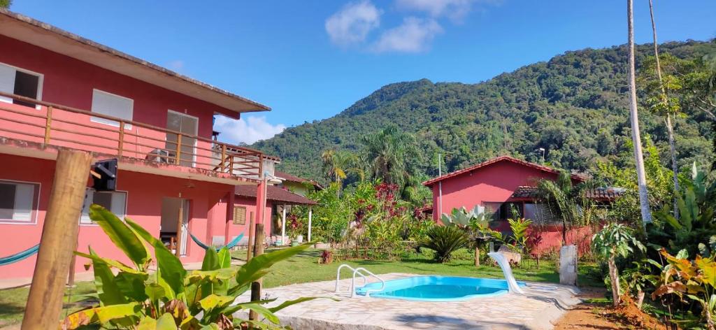 a house with a swimming pool in front of it at Rancho Vista Verde in Ubatuba