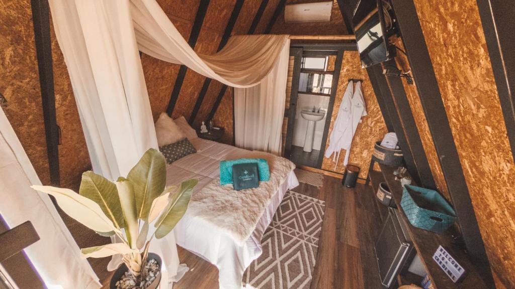 an overhead view of a room with a bed in a house at Cardinal Glamping in Guatapé