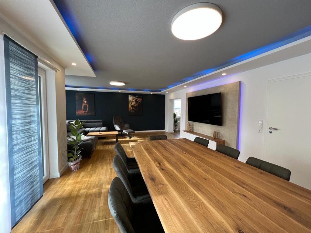 a conference room with a large wooden table and chairs at Ferienhaus LEMA in Schopfloch