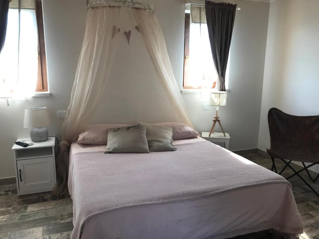 Postel nebo postele na pokoji v ubytování Agriturismo B&B Le Casette sul Garda