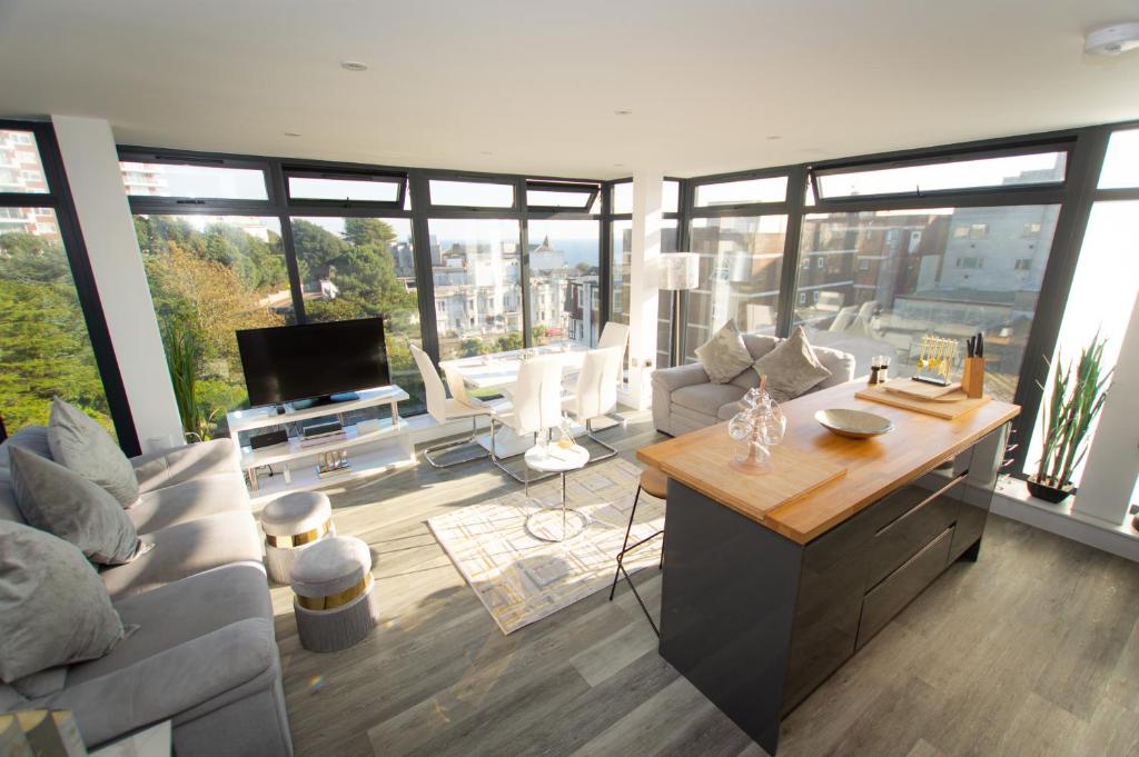 a living room with a couch and a tv at * PANORAMIC PENTHOUSE WITH SEA & CITY VIEWS in Bournemouth