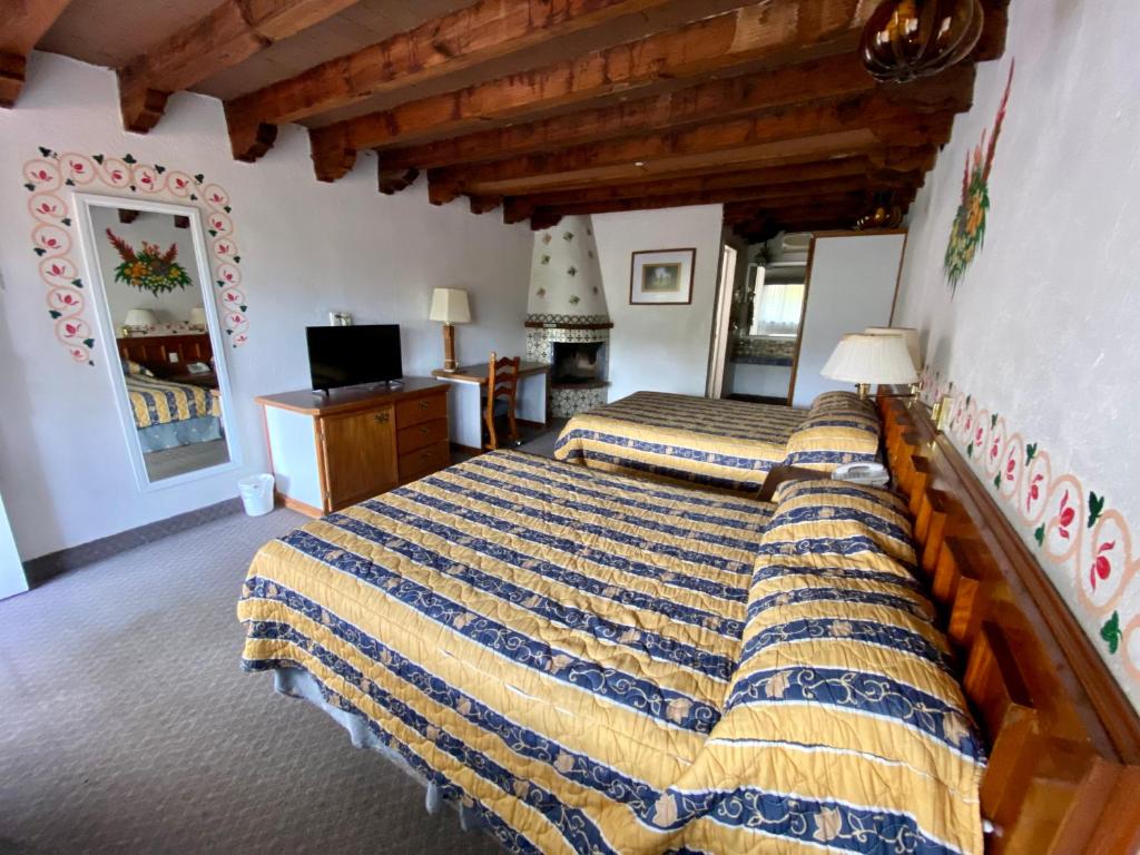 Postel nebo postele na pokoji v ubytování Hotel Posada Vista Bella