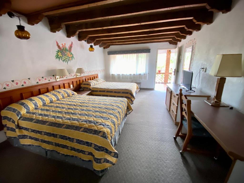 Postel nebo postele na pokoji v ubytování Hotel Posada Vista Bella