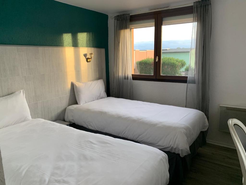 Postel nebo postele na pokoji v ubytování Hôtel Le Forestia