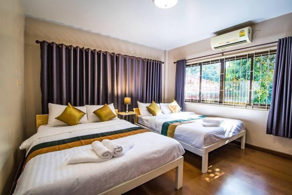 a bedroom with two beds and a window at Vanilla house heart of Sattahip in Sattahip