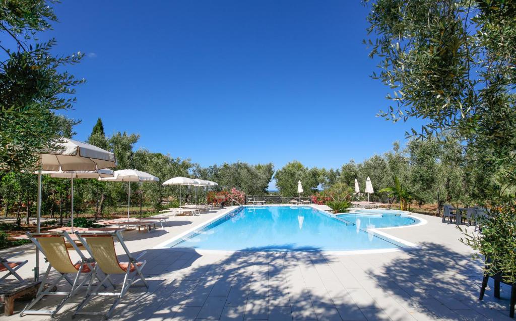 basen w ośrodku z leżakami i parasolami w obiekcie Agriturismo Posta Pastorella w mieście Vieste