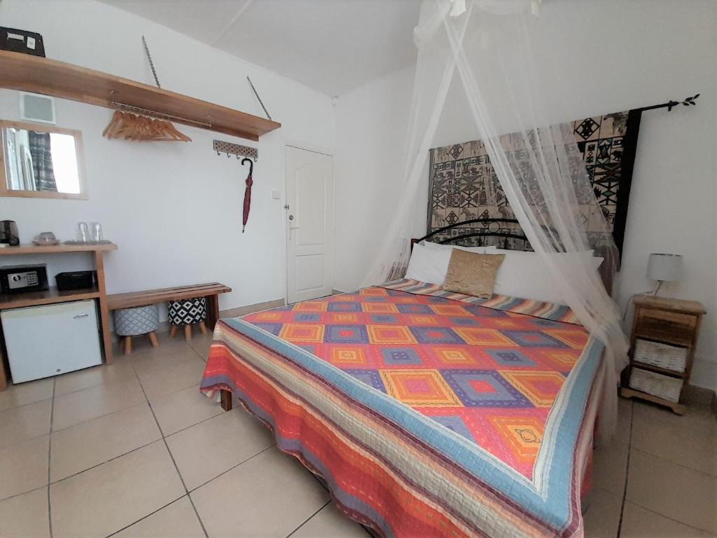 Postel nebo postele na pokoji v ubytování Villa Osumare Guest House
