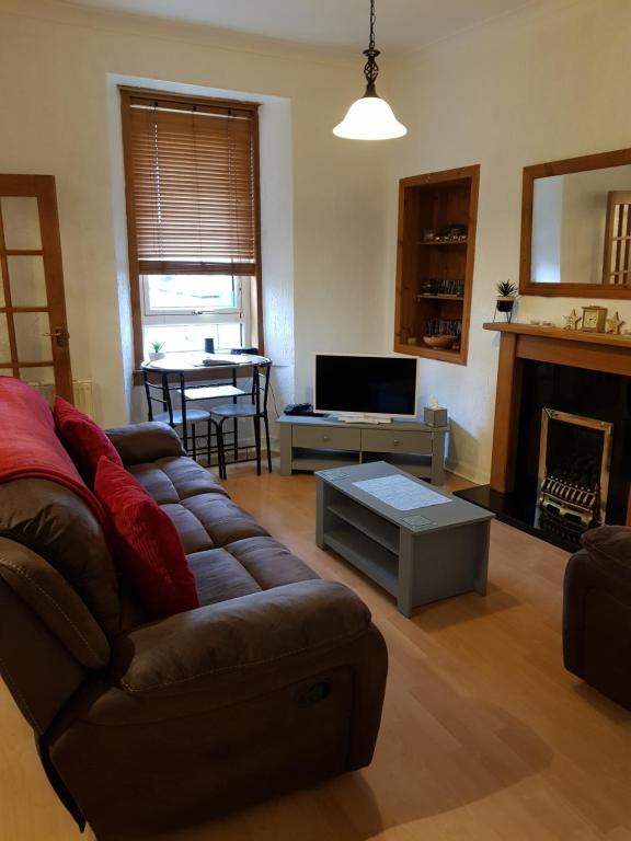 a living room with a couch and a table at Brucefield Avenue in Dunfermline