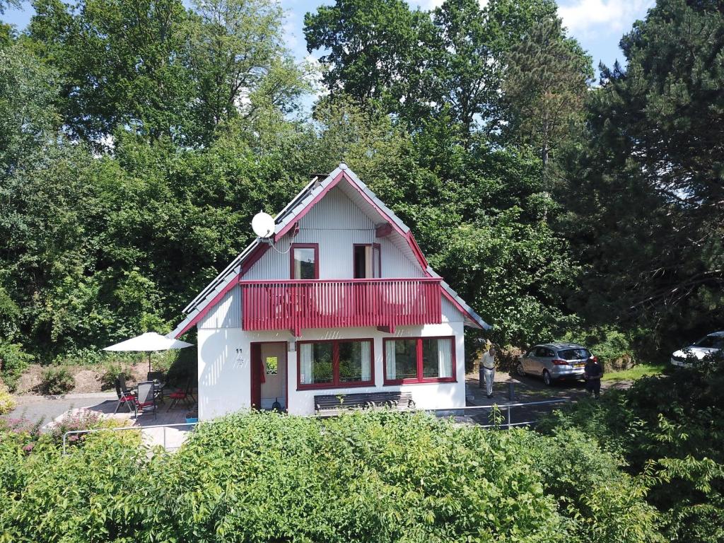 a small white house with a red roof at Ferienhaus Seeblick KIR011 in Kirchheim
