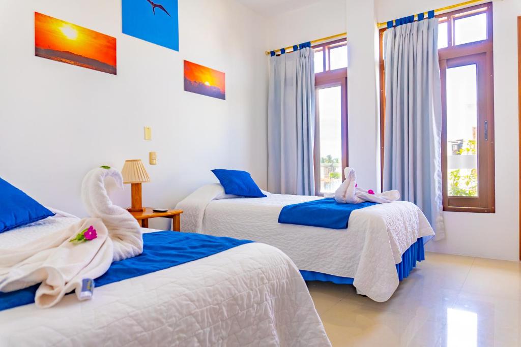 Postel nebo postele na pokoji v ubytování Gran Hostal Tintorera