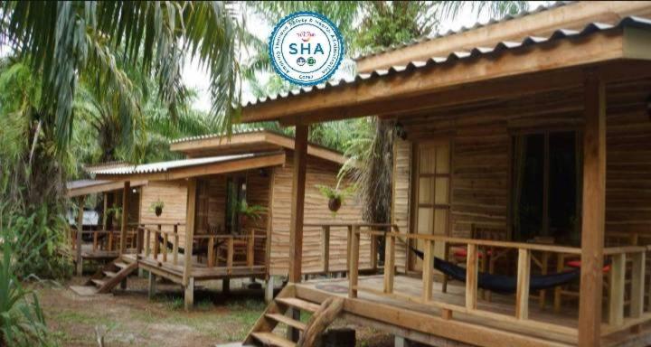 a wooden cabin with a sign on top of it at Mada Lanta Mai Keaw in Ko Lanta