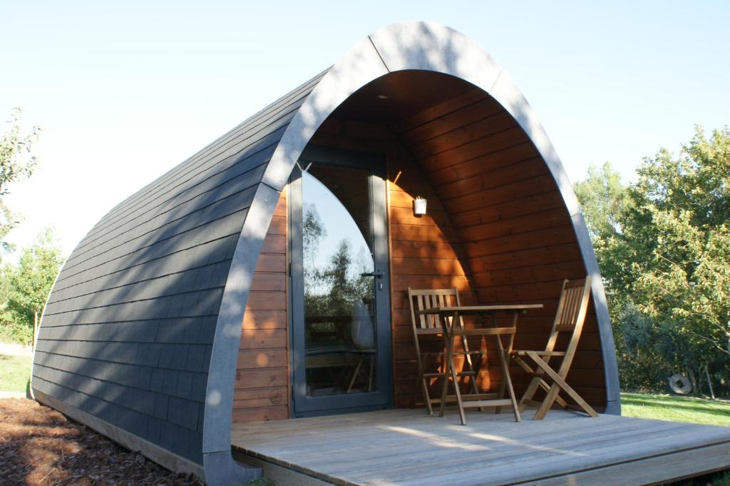 a dome house with a table in it at Casa Matilde - Alombada Family Lodge in Águeda