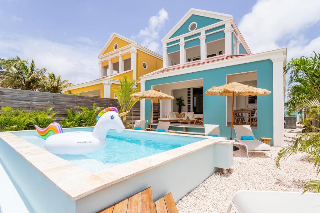 a villa with a pool in front of a house at Villa Laguna in Water Villas in Kralendijk