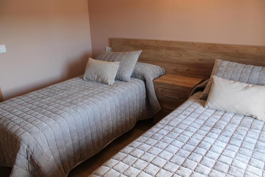 A bed or beds in a room at Apartamentos Turísticos ESCORRALADAS
