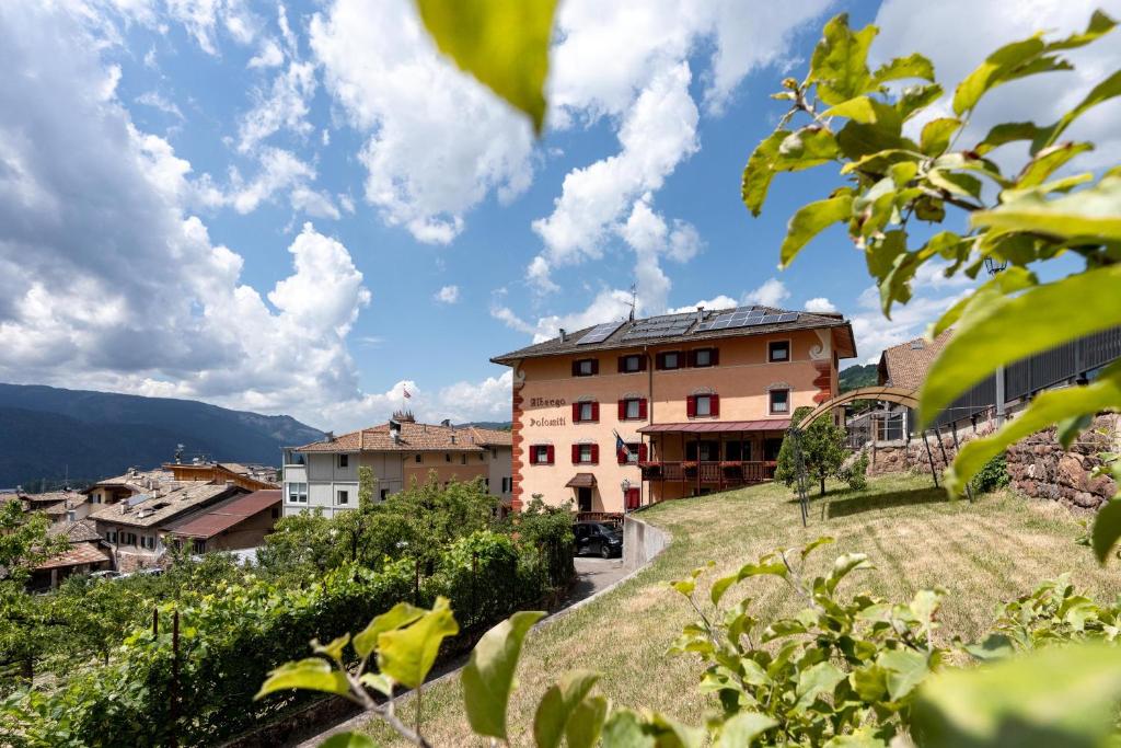 a view of a village with a building at Albergo Dolomiti in Cavalese