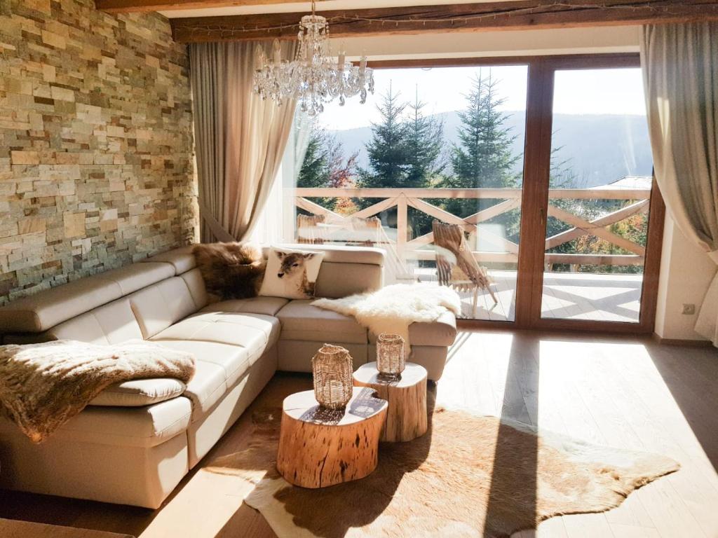 a living room with a couch and two tables at Chalet Rebeca 12 beds Donovaly in Donovaly
