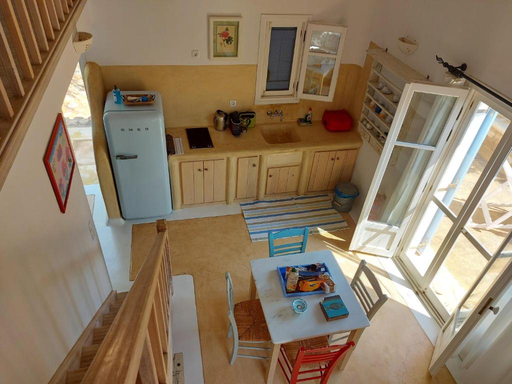 an overhead view of a kitchen with a table and refrigerator at Simos suites in Elafonisos
