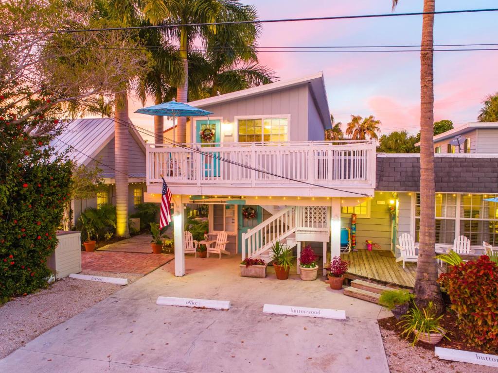 a house with a balcony and an umbrella at Foxtail in Siesta Key