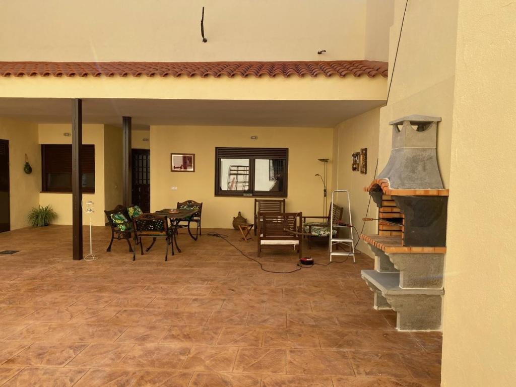 a living room with a pizza oven and a table at SILBO RURAL in Borox