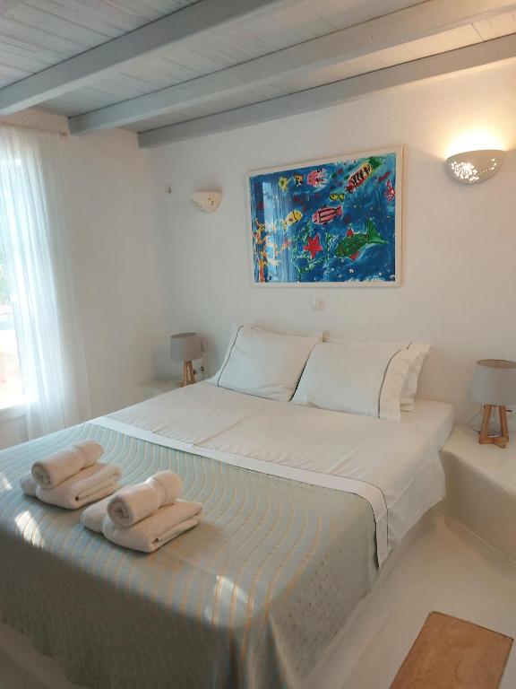 a bedroom with a bed with two towels on it at Simos suites in Elafonisos