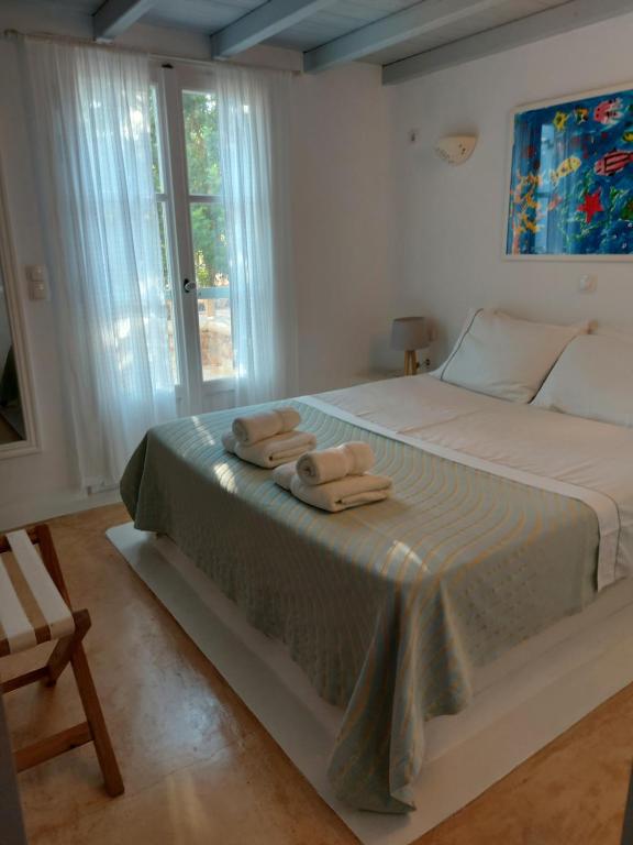 a bedroom with a bed with two towels on it at Simos suites in Elafonisos