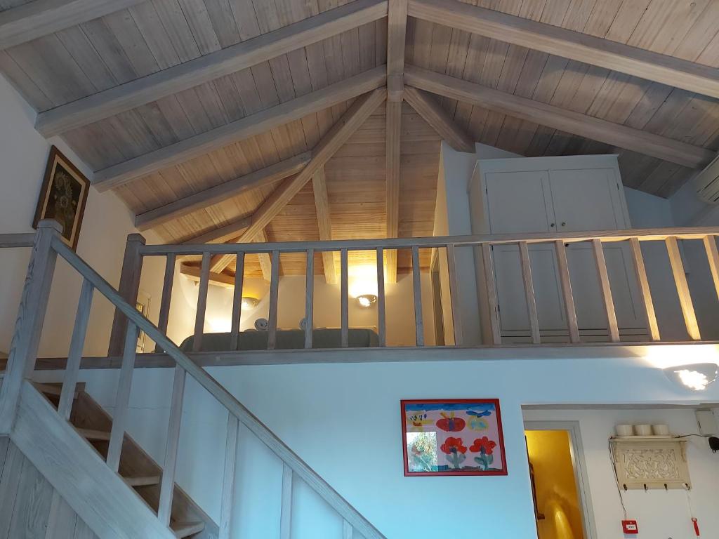 a staircase in a house with a wooden ceiling at Simos suites in Elafonisos