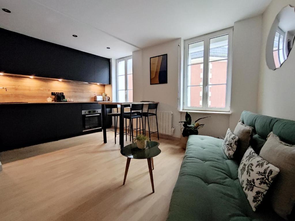 a living room with a couch and a table at My Duplex House Trouville in Trouville-sur-Mer