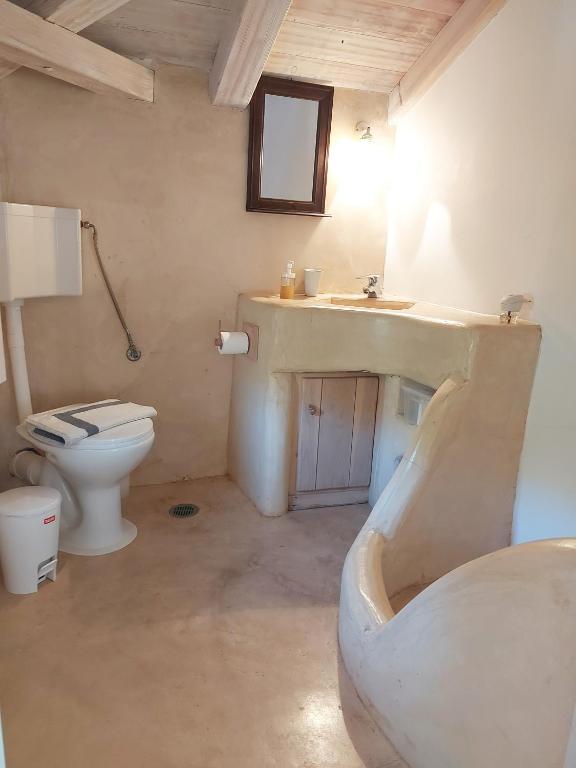 a bathroom with a sink and a toilet at Simos suites in Elafonisos