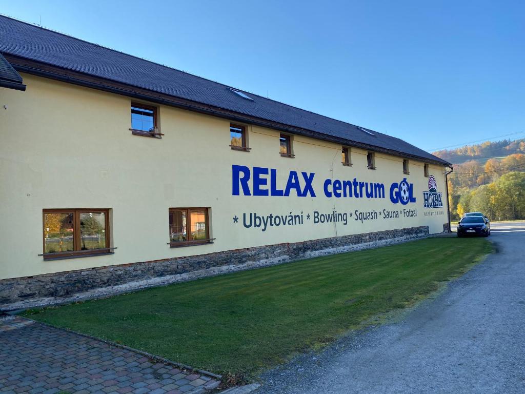 a building with a sign on the side of it at Relax Centrum Gól in Loučná nad Desnou