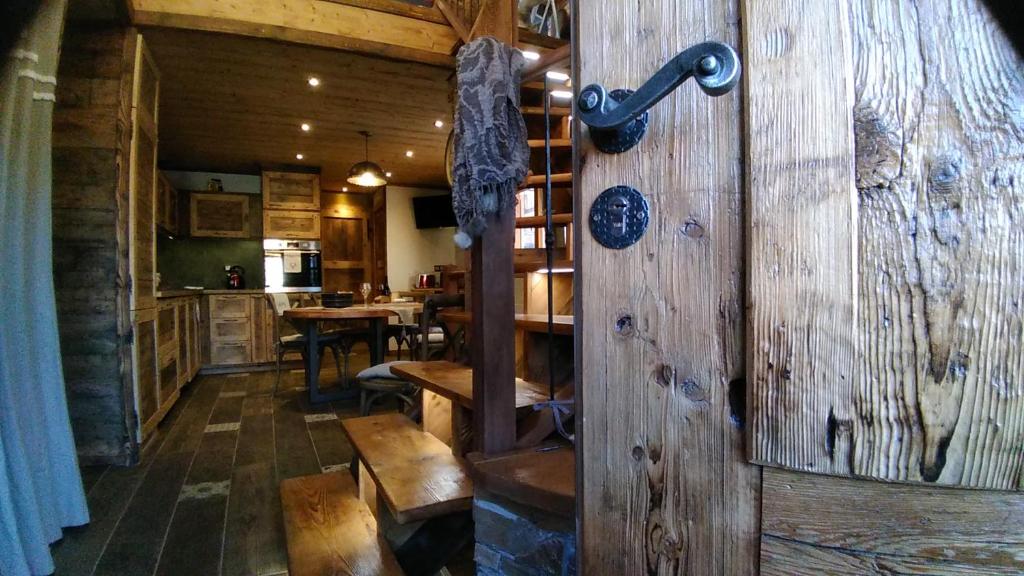 a room with a wooden wall with a wooden table at LE BAROQUE in Aime-La Plagne