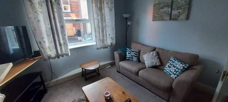 a living room with a couch and a table at Ripon Street Lincoln in Lincoln