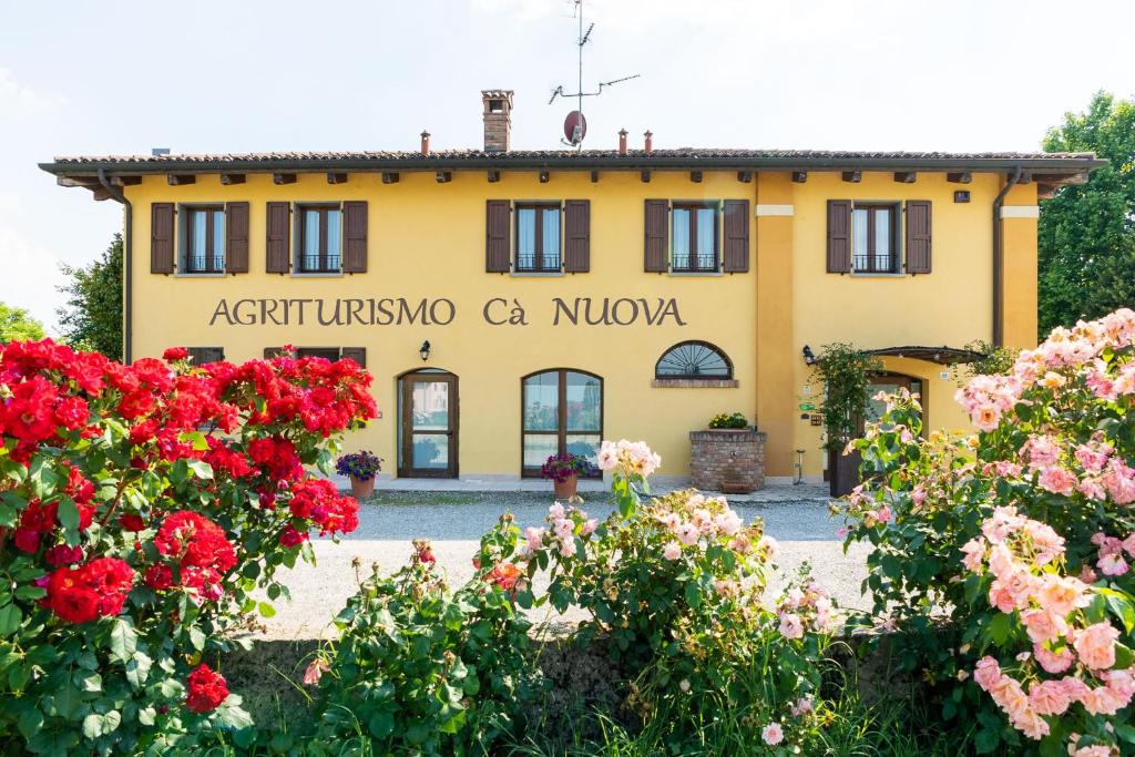 a building with flowers in front of it at Agriturismo Cà Nuova in Minerbio