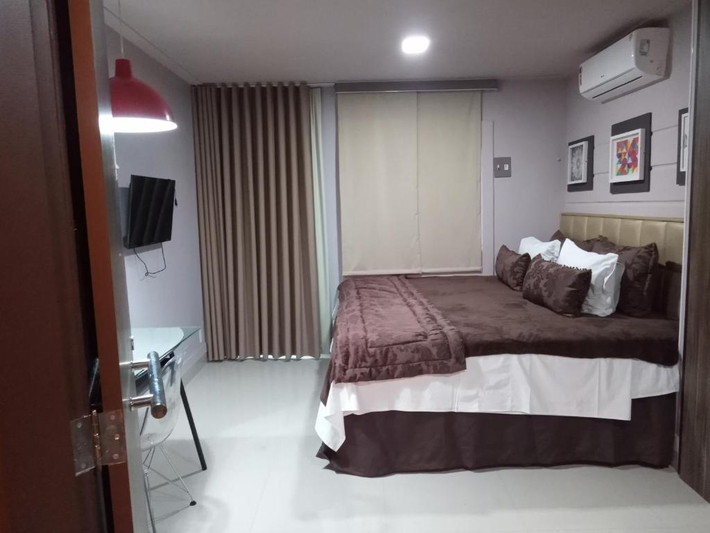 
A bed or beds in a room at Hotel Bangalô Belém
