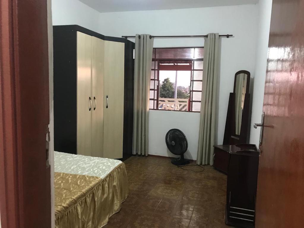 a hotel room with a bed and a window at CAPIVARI POUSADA B&B in Capivari