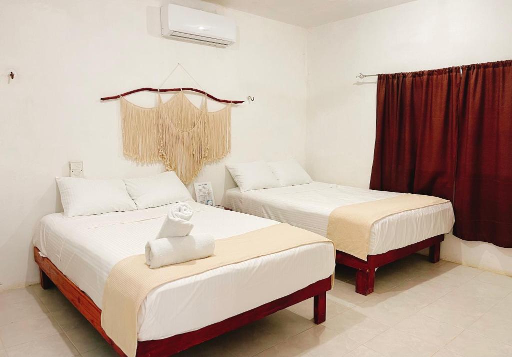 Postel nebo postele na pokoji v ubytování La casa del pescador Holbox