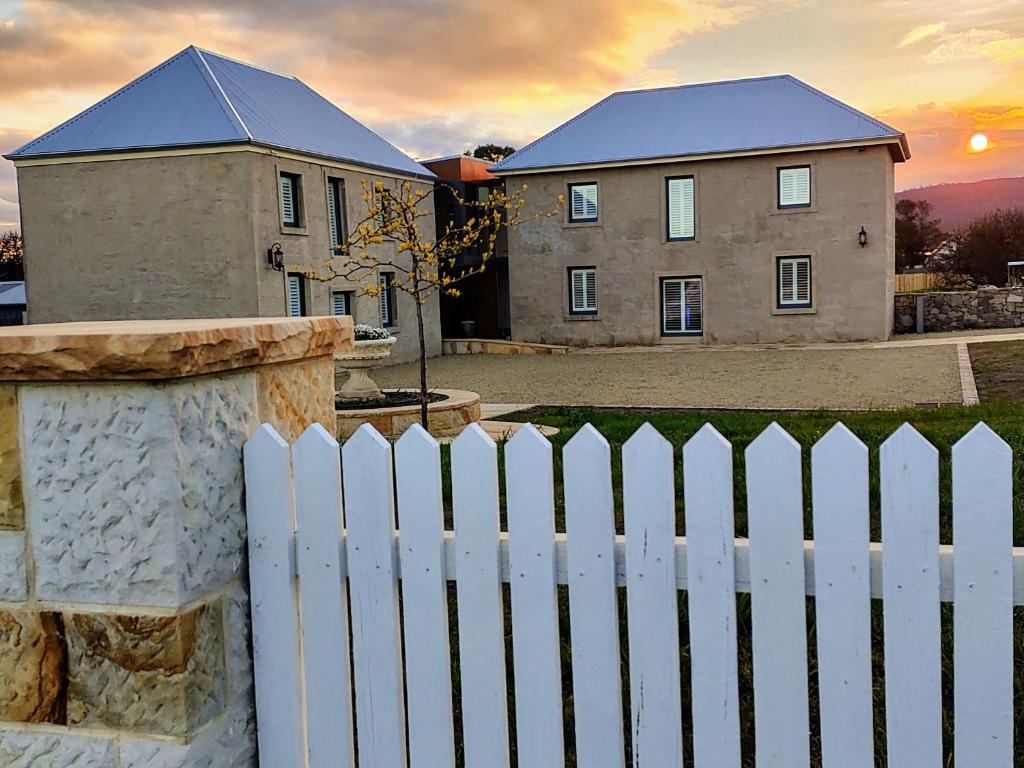 a white picket fence in front of a house at Triabunna Barracks in Triabunna