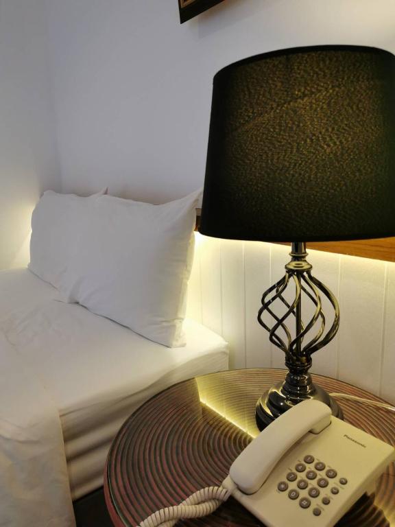 Postel nebo postele na pokoji v ubytování BaanBusarin Hotel