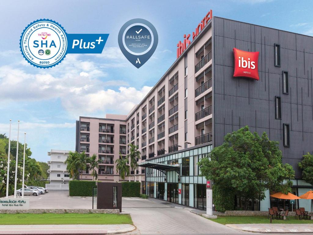 a rendering of a hotel with the sign for the hotel plus at Ibis Hua Hin in Hua Hin