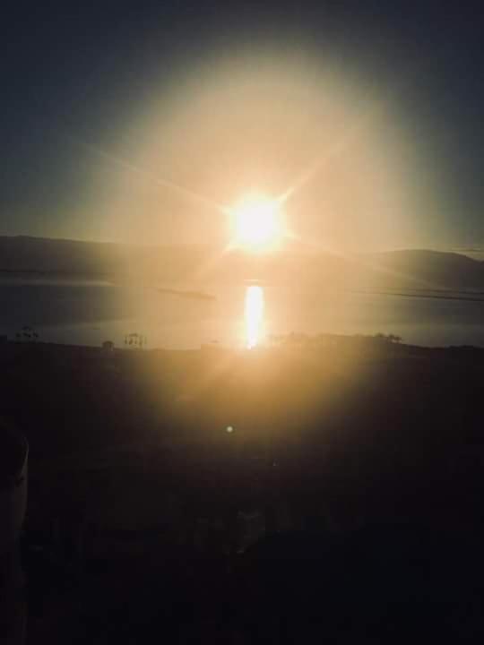 a sunset over the ocean with the sun in the sky at Manakau House The Old Manakau Hotel 1920 in Manakau