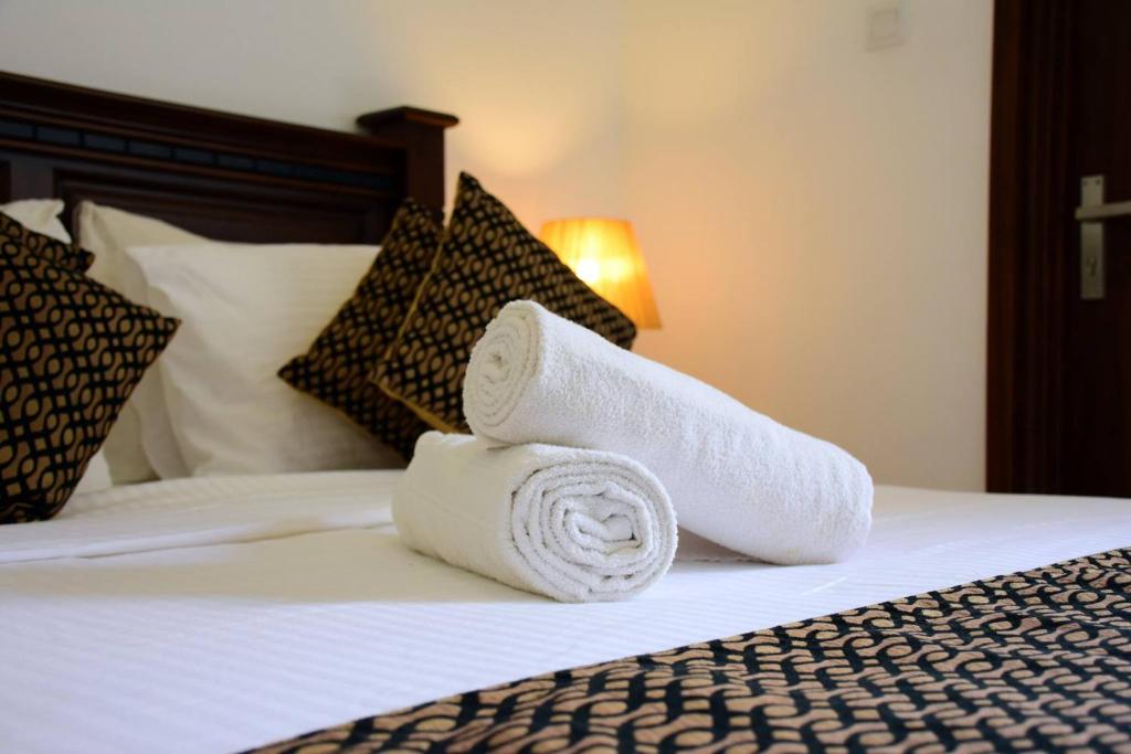 Postel nebo postele na pokoji v ubytování Hotel Bamiyan